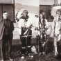 Black and white photograph of a translator with three Ojibwe men. The Ojibwe leader Miskogwan (Red Feather) stands on the far right. Northwest School of Agriculture Dedication Day, October 5, 1920.