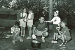 Black and white photograph of campers cooking outdoors at Dick Butwin Day Camp, 1967.