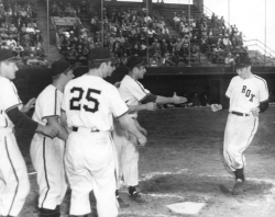 Chick Simunek is greeted at home plate after hitting a grand slam during a June 20, 1951 game at Rox Stadium, 1951.