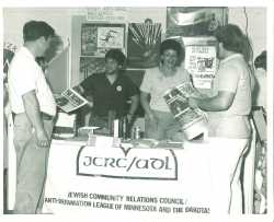 Black and white photograph of booth staffed by members of the JCRC/ADL at the Minnesota State Fair, c.1986.
