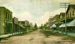 Colorized tinted photographic postcard showing Lewis Street in Watertown, c.1909.