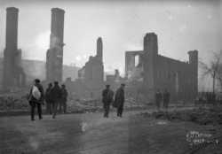 Black and white photograph of people and ruins after the fire, 1918.