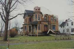 Photograph of badly damaged house. 