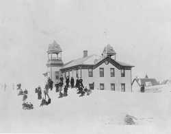 photograph of Dawson school with children playing in the snow.
