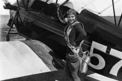 Black and white photograph of Klingensmith with one of her aircraft, a Waco biplane, ca. 1930.