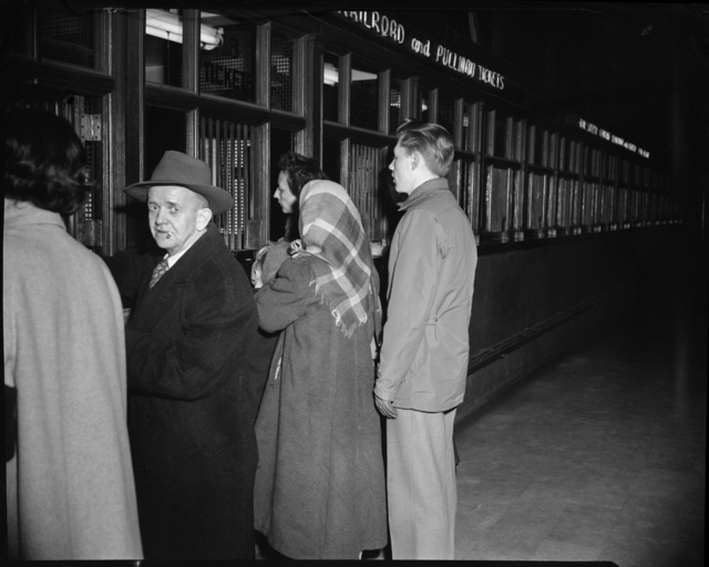 Passengers purchase train tickets at the St. Paul Union Depot.