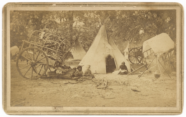 Black and white photograph of a Red River cart at a Dakota family’s camp, ca. 1870. 