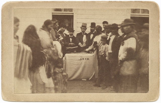 Black and white photograph of annuities being paid at the Fond Du Lac reservation, c.1865.