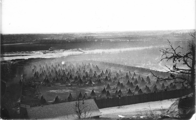 Black and white photograph of the the Dakota concentration camp on the river flats below Fort Snelling, c.1862–1863.