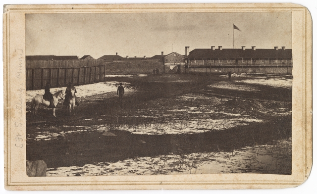 Black and white photograph the south side of Fort Snelling showing the gatehouse and shops, c.1864.