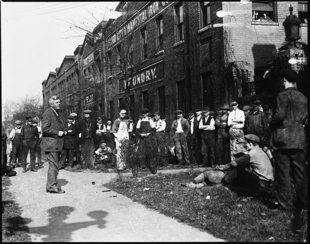 Theodore Christianson speaking to striking workers outside Flour City Ornamental Iron Works