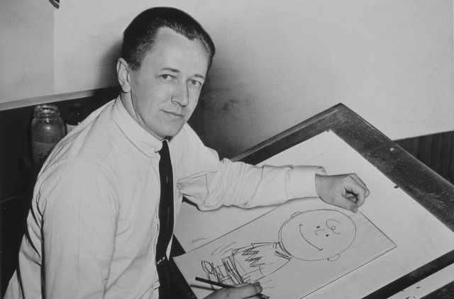 Charles Schulz with a drawing of Charlie Brown