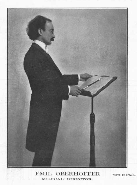 Black and white photograph of Oberhoffer at behind a podium, c.1903. 