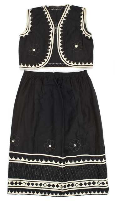Color image of a child's black-and-white cotton vest and skirt made in India, 1967.