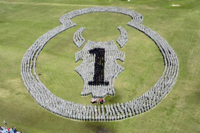 Color image of our thousand members of the division’s First Brigade Combat Team creating a new “animated” Red Bull emblem at Camp Shelby, Mississippi, just prior to departure for Iraq, March 2006.