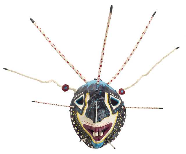 Color image of a carved coconut-shell vejigante mask made by Puerto Rican-Minnesotan artist and musician Ricardo Gómez c.1995.