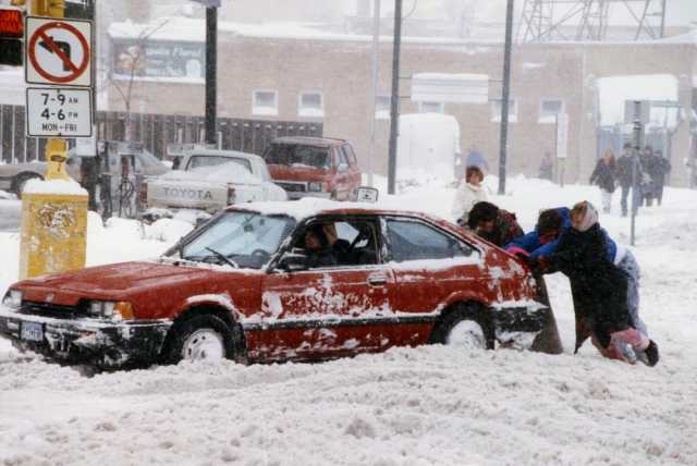 Color image of a car stuck in the snow during the Halloween Blizzard, 1991. Photograph by Duane Braley, Minneapolis Star Tribune.
