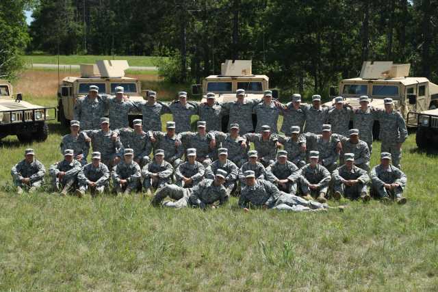 Color image of a platoon of the 34th Military Police Company, 34th Infantry Division, during annual field training at Camp Ripley, June 2016. 