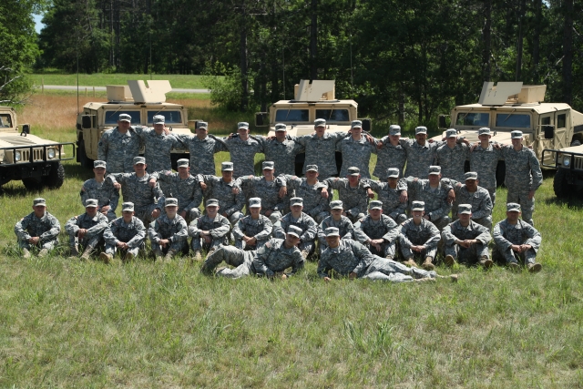 Color image of a platoon of the 34th Military Police Company, 34th Infantry Division, during annual field training at Camp Ripley, June 2016. 