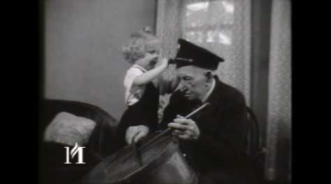 Film titled “Albert Woolson Before Death.” It shows Albert Woolson holding his Civil War portrait, playing a drum, smoking a cigar, and receiving bags of mail. Black and white, 16mm, sound film, August 2, 1956. KSTP-TV Archive, Minnesota Historical Society, St. Paul. To view the clip, click the link below.