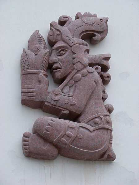 Color image of a corn god holding an ear of corn. Photograph by Wikimedia Commons user ŠJů, 2012. 