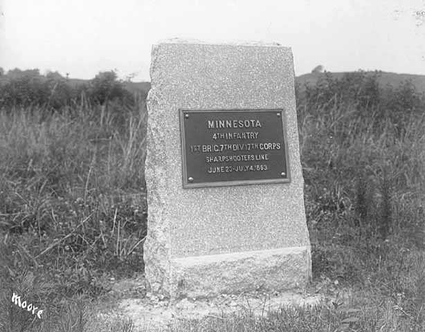 Photograph of a rectangular stone monument with metal plaque honoring the Fourth Minnesota regiment