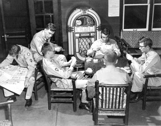 Black and white photograph of after-hours relaxation in Camp Ripley’s Enlisted Service Club, 1958.  