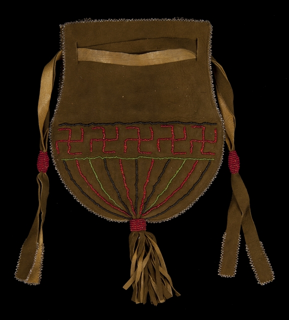 Color image of a fringed and beaded Dakota bag with drawstring closure created in the 1930s for sale to tourists.