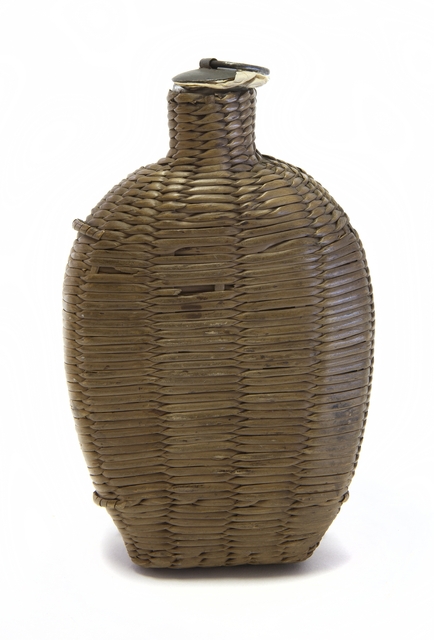 Wicker covered glass canteen.