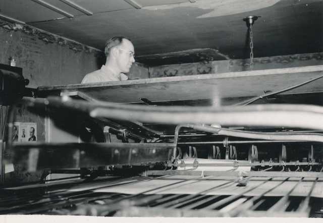 Black and white photograph of a Waconia Patriot employee uses a printing press. Date and photographer unknown.