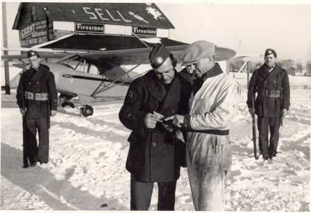 Black and white photograph of Elmer Sell and others at Sell Airfield.