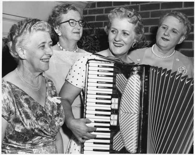 Photograph of Coya Knutson playing her accordion