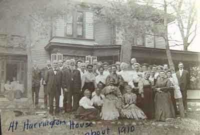 Black and white photograph of a group of people at the Harrington-Merrill House, c.1910.