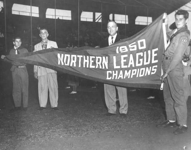 Boy Scouts and Rox management hold up their 1950 championship banner, c.1951. From the Myron Hall Collection, Stearns History Museum and Research Center, St. Cloud.
