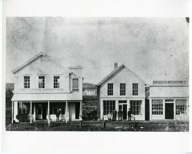 Black and white photograph of Van Campen store and Scofield's drug store, 1883. 
