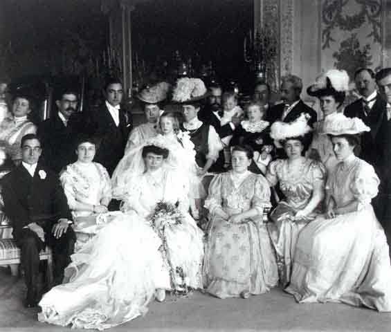 Black and white photograph of the Gertrude Hill–Michael Gavin wedding party in the James J. Hill House drawing room, 1906. Photographer: T.W. Ingersoll.