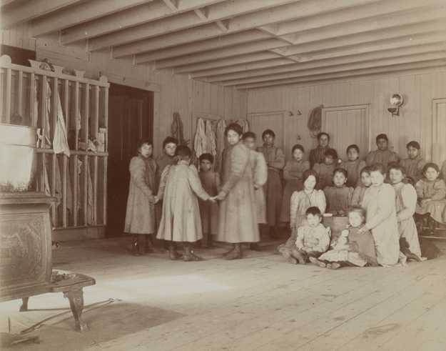 Black and white photograph of students at a Native American board school, c.1900.