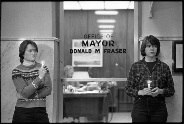 Black and white photograph of a candlelight vgil at Mayor Fraser’s office, 1983. 