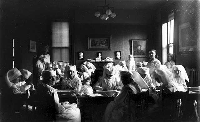 Black and white photograph of Red Cross workers making bandages, c.1916.