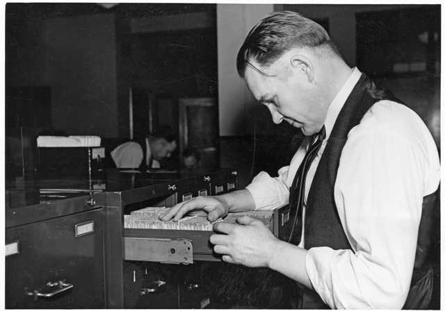 Photograph of a St. Paul Police worker revising police records
