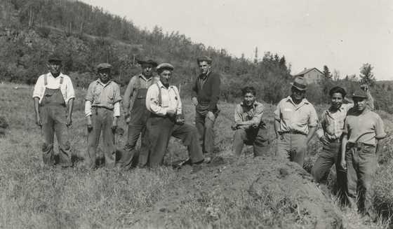 Black and white photograph of Indian Civilian Conservation Corps crew on the stockade site at the end of the first day of work, Grand Portage, Minnesota, 1937. Photographed by Willoughby Maynard Babcock, Jr.