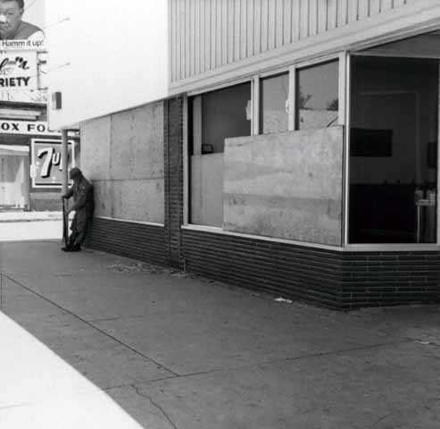 Black and white photograph of boarded-up storefronts on Plymouth Avenue in North Minneapolis, July 1967. Photographed by Twiggs.