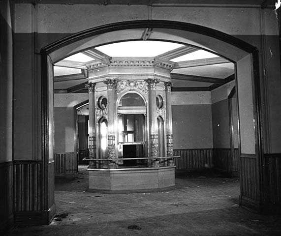 Black and white photograph of the flag case in the rotunda of the second capitol prior to demolition, 1937. Photographed by the Minneapolis Star Journal.