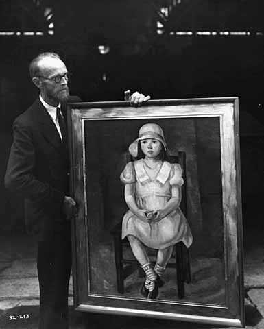 Black and white photograph of Knute Heldner holding a painting created by Elsa Jemne for the WPA Federal Art Project and exhibited at the Minnesota State Fair, c.1936.