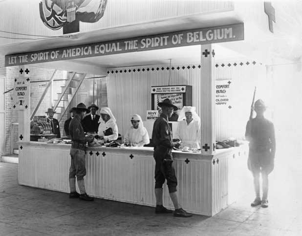 Black and white photograph of a Red Cross booth ("Let the Spirit of America Equal the Spirit of Belgium") at the 1917 Minnesota State Fair.