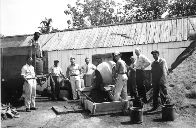 Black and white photograph of men working on a fair building at the Murray County Fairgrounds in Slayton, 1950s.