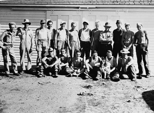 Black and white photograph of German prisoners of war outside a farm building in Moorhead, ca. 1943–1945. Used with the permission of the Historical and Cultural Society of Clay County. 