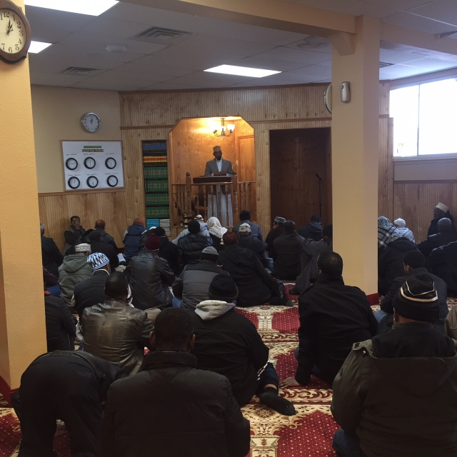 Color image of Friday prayer at Dar Al-Hijrah Mosque, 2015. 