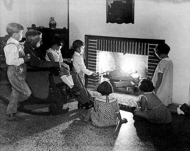 Black and white photograph of Dr. Henry Longstreet Taylor entertaining children at the Ramsey County Preventorium, c.1930. 