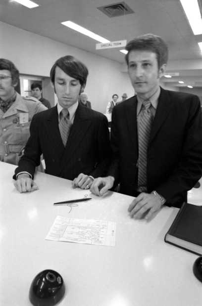 Black and white photograph of Jack Baker and James Michael McConnell applying for a marriage license in Minneapolis, 1970.